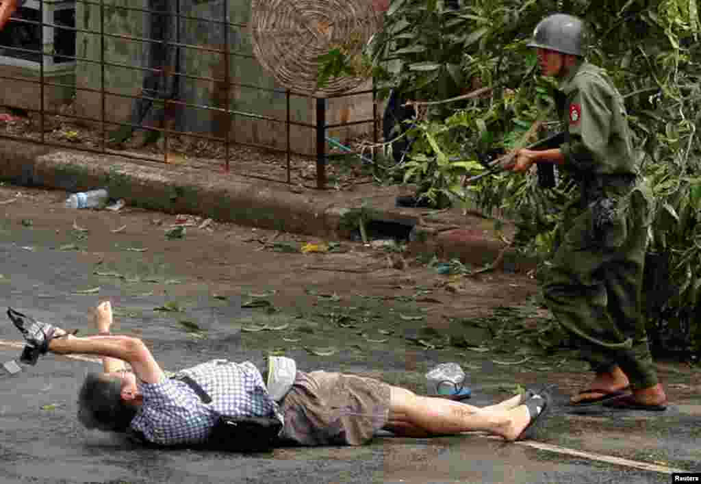 In this unseen footage released, April 26, 2027, by the family of slain Japanese journalist, Kenji Nagai of APF News, tries to take photographs as he lies injured after police and military officials fired upon and then charged at protesters in Yangon&#39;s city center, Myanmar, Sept. 27, 2007.