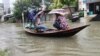 রাজশাহীতে রেকর্ড বৃষ্টির কারণে কোথাও কোথাও যানবাহনের পরিবর্তে নৌকায় করে চলাচল করছে মানুষ। ৪ অক্টোবর, ২০২৩।