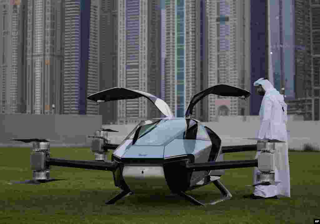 A man looks at the XPeng X2, an electric flying taxi developed by the Guangzhou-based XPeng, Inc&#39;s aviation affiliate, being tested in front of the Marina District in Dubai, United Arab Emirates.