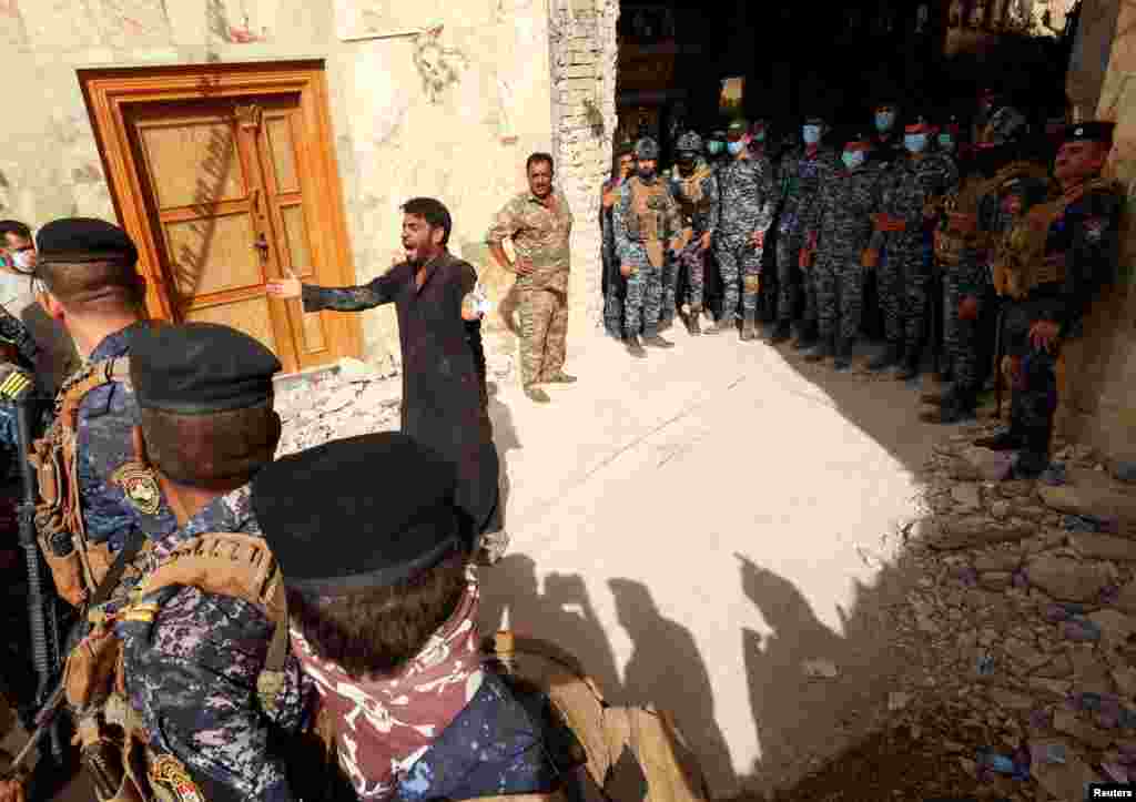 A man reacts as Iraqi rescue workers search for survivors in the rubble following a landslide that hit Qattarat al-Imam Ali shrine on the outskirts of the holy city of Kerbala, Iraq, Aug. 21, 2022. 