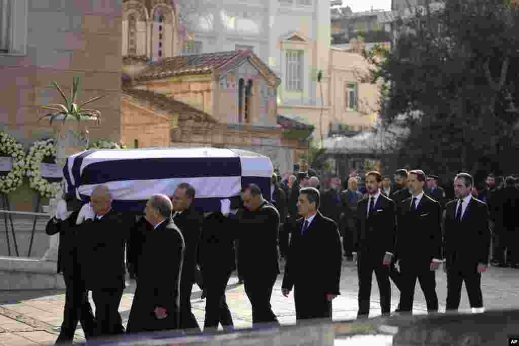 Prince Philippos, left, Prince Pavlos, center, and &nbsp;Prince Nikolaos, right, sons of former king of Greece Constantine II, walk behind their father coffin as they arrive at the Metropolitan cathedral for his funeral in Athens.&nbsp;