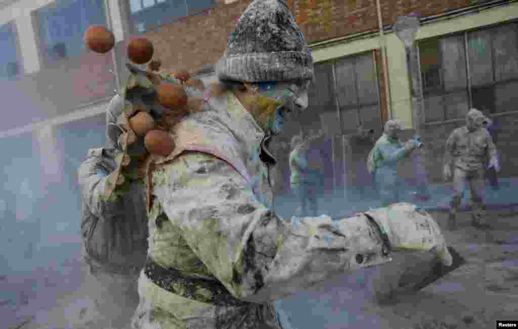 Revelers take part in the traditional &quot;Els Enfarinats&quot; (The Floured) festival, in the town of Ibi, Alicante Province, Spain.