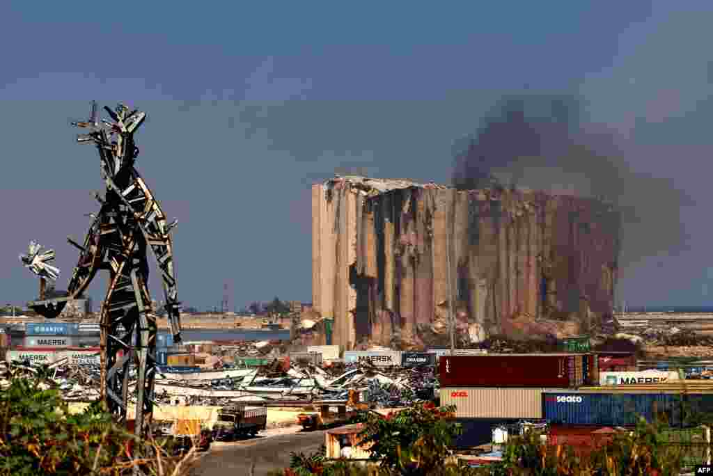 Smoke rises from Beirut&#39;s grain silos that were severely damaged in 2020 by an enormous explosion. The fire at the silos, at risk of collapse due to severe damage, ignited at the start of the month because of fermentation of remaining grain stocks, paired with rising temperatures.