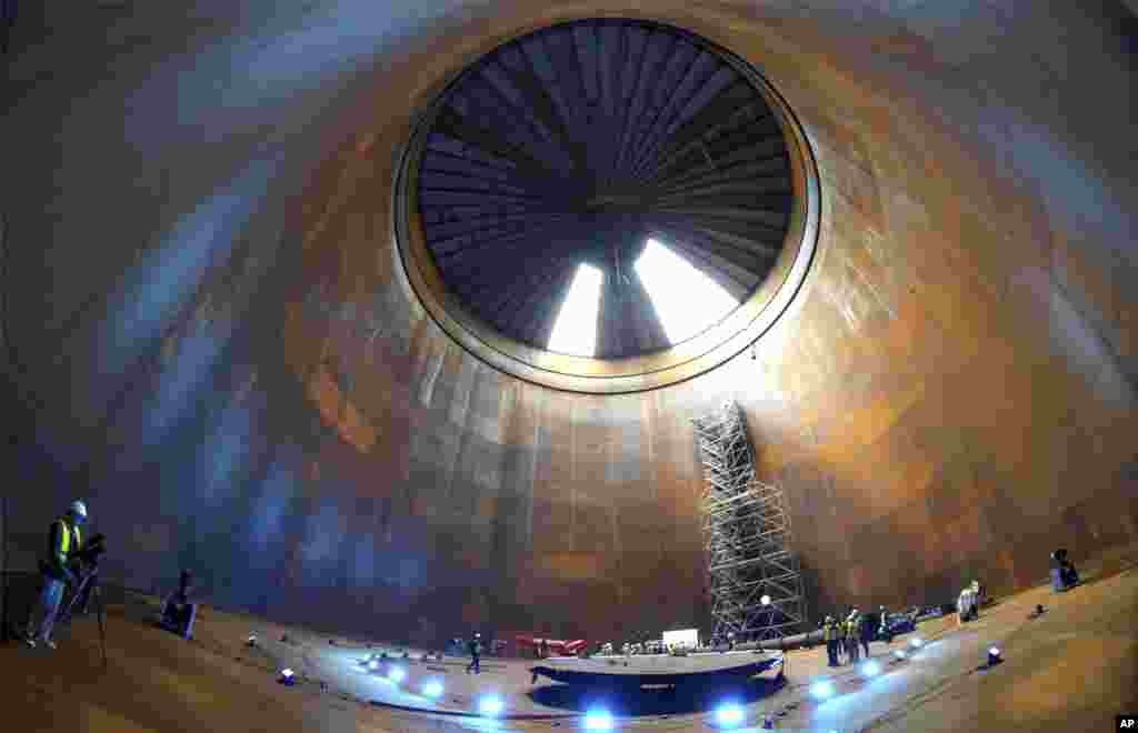 Journalist are seen inside a vast thermal tank to store hot water in Berlin, Germany.&nbsp;Power provider Vattenfall unveiled a new facility that turns solar and wind energy into heat, which can be stored in a vast thermal tank and released into the capital&#39;s grid as needed, smoothing out the fluctuating supply problem of renewables.