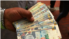 En la foto de archivo, un cambista sostiene billetes de soles peruanos en una calle del centro de Lima. 15 de diciembre, 2017. REUTERS/Mariana Bazo
