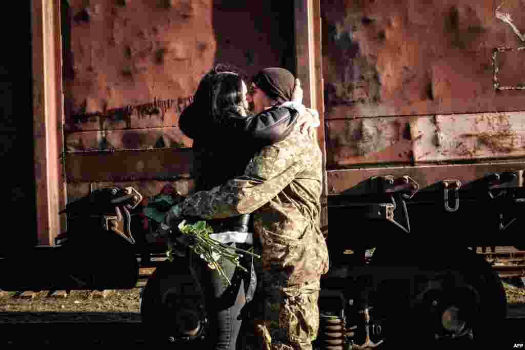 A Ukrainian serviceman embraces his partner upon her arrival from Kyiv at Kramatorsk train station, amid the Russian invasion of Ukraine. 