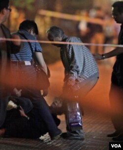 天安门母亲创办人之一丁子霖在北京木樨地儿子被枪杀地点周年祭奠时在她的丈夫蒋培坤（右二）身旁崩溃。他们的儿子蒋捷连在八九六四民主运动期间被戒严解放军开枪打死。（2010年6月3日）