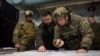TOPSHOT - This handout photograph taken and released by the Ukrainian Presidential Press Service on November 30, 2023 shows Ukrainian President Volodymyr Zelensky (C-L) and Colonel General Oleksandr Syrskyi (C-R) visiting of Ukraine's army command post in