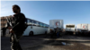 Families evacuated from Kabul, Afghanistan, walk through the terminal before boarding a bus after they arrived at Washington Dulles International Airport, in Chantilly, Va., on Friday, Aug. 27, 2021. (AP Photo/Jose Luis Magana)