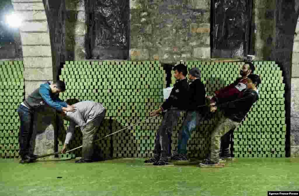 Syrian workers cut laurel soap at the Jbaili soap factory, an 800-year-old artisanal soap manufacturer, in the old city of Syria&#39;s northern city of Aleppo, Jan. 24, 2022.