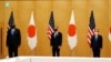 资料照片：美国国务卿布林肯（中）和美防长奥斯汀（左）在东京与日本首相菅义伟合影。（2021年3月16日）
