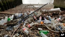 Des bouteilles en plastique et d'autres plastiques, dont une vadrouille, reposent sur la rive nord de la Tamise à Londres le 5 février 2018. (AP Photo/Matt Dunham, dossier)