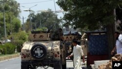 Afghan security personnel gather in front of a prison after an attack in the city of Jalalabad, east of Kabul, Afghanistan, Monday, Aug. 3, 2020. An Islamic State group attack on the prison in eastern Afghanistan holding hundreds of its members…