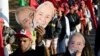 Los miembros del Movimiento de los Sin Tierra, con máscaras del expresidente brasileño, Luiz Inácio Lula da Silva, participan en la marcha "Lula libre" cerca de Brasilia, el 14 de agosto de 2018.