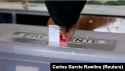 Un ciudadano deposita su voto en un local de votación en Santiago, Chile, el 19 de noviembre de 2017.